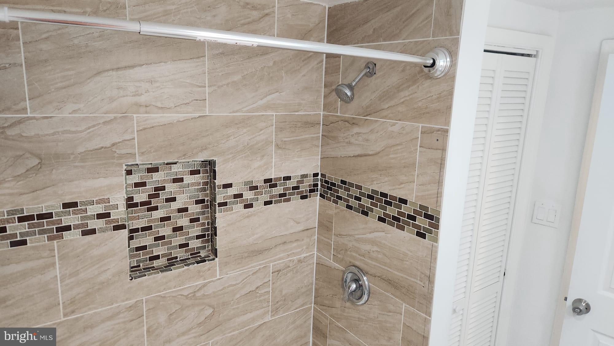 519 East 28th Street Baltimore, MD 21218 - Photo 33 of 46 Elegant tiled shower with modern accents.
