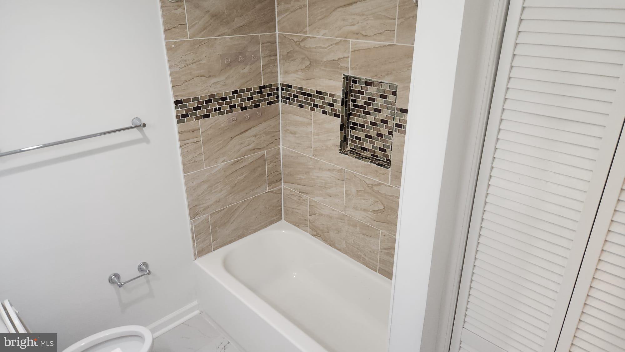 519 East 28th Street Baltimore, MD 21218 - Photo 34 of 46 Modern bathroom with elegant tile accents.