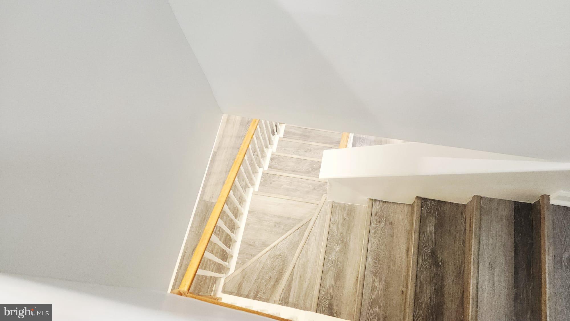 519 East 28th Street Baltimore, MD 21218 - Photo 42 of 46 Elegant staircase bathed in natural light.