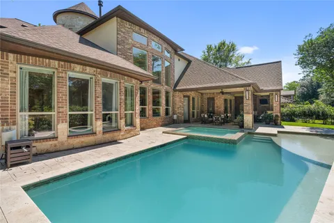 a view of house with swimming pool yard and outdoor seating