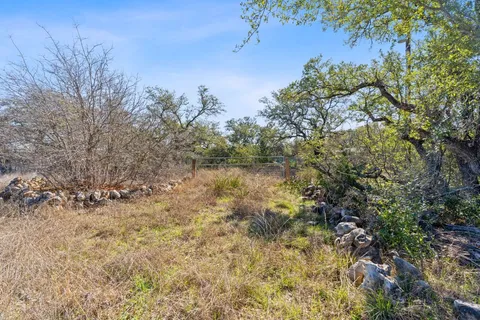 a view of a houses with a lush green hillside