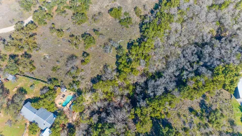 a backyard of a house with lots of trees