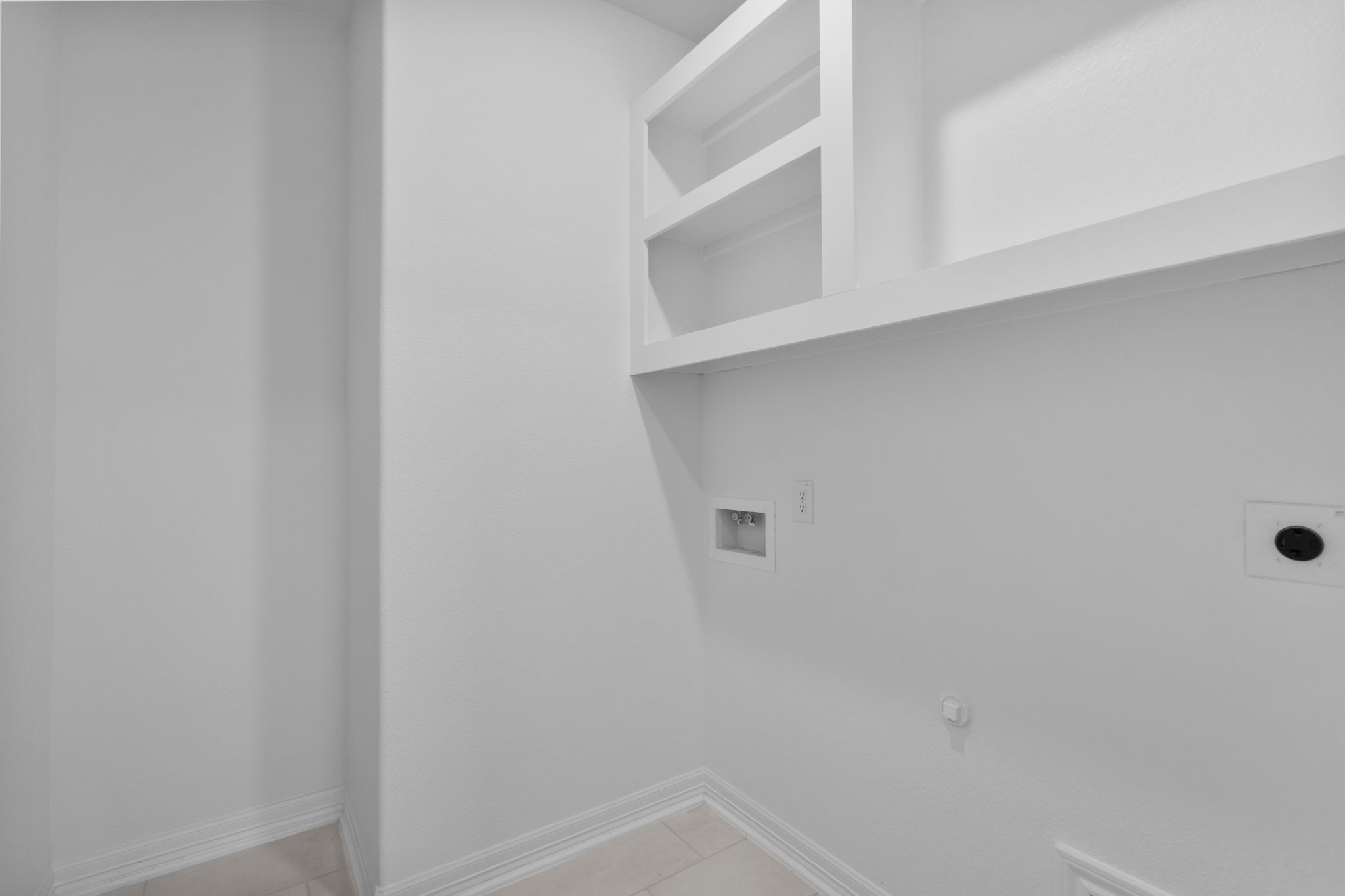 10639 Forward Street Richmond, TX 77469 - Photo 19 of 31 The utility room pairs function with finish, making daily routines feel effortlessly polished.