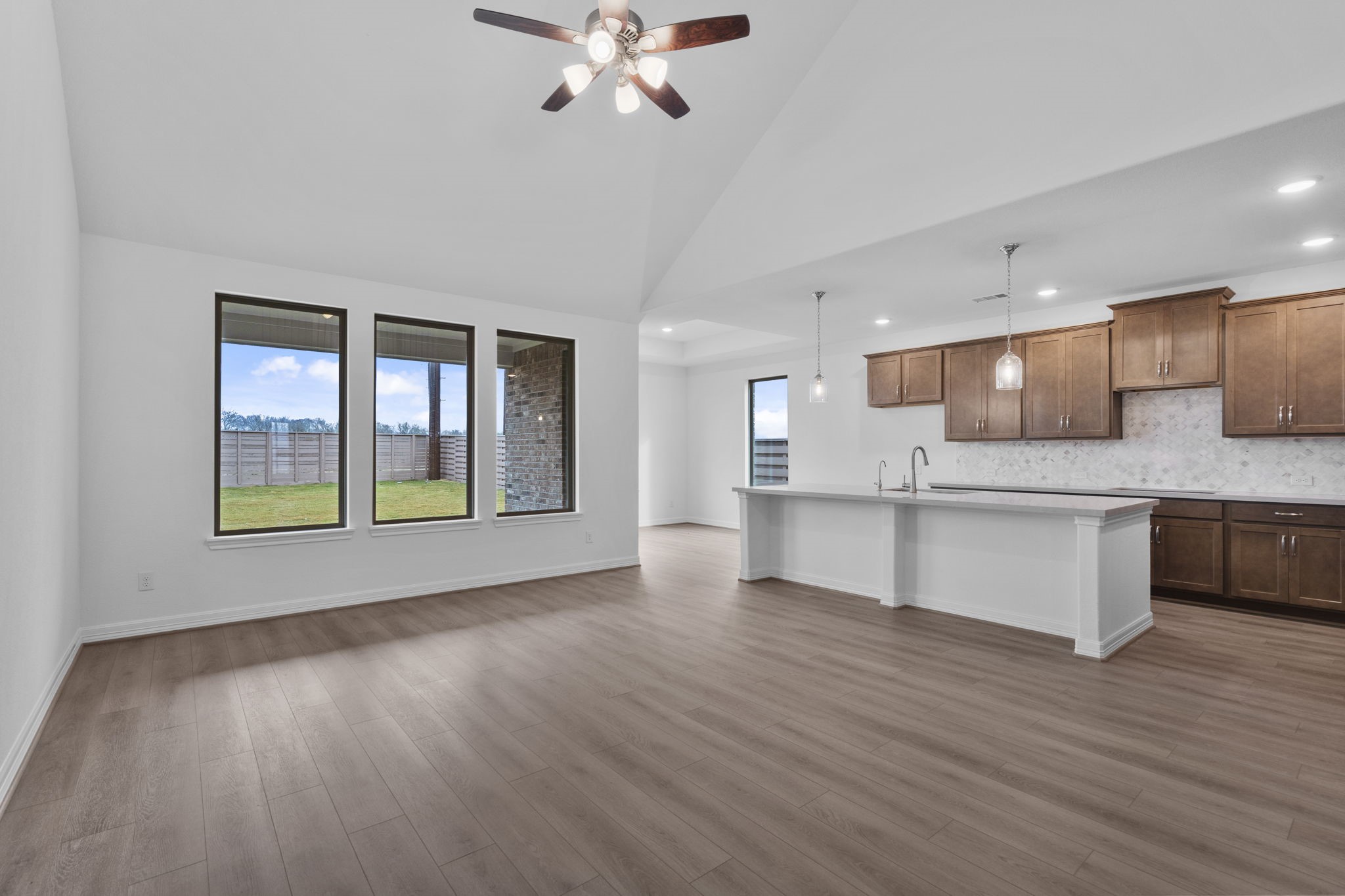 10639 Forward Street Richmond, TX 77469 - Photo 5 of 31 Oversized windows in the family room allow ample light in this open concept living space.
