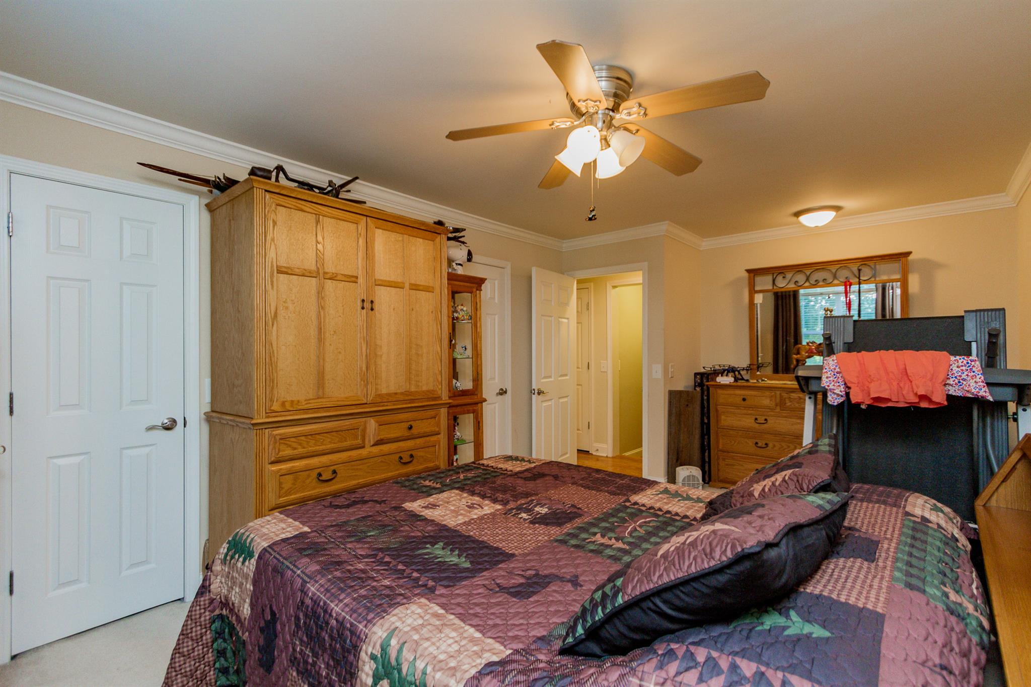 3701 Oakland Road Springfield, TN 37172 - Photo 10 of 22 a bedroom with a bed and a chandelier