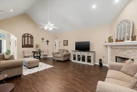 a living room with furniture fireplace and flat screen tv