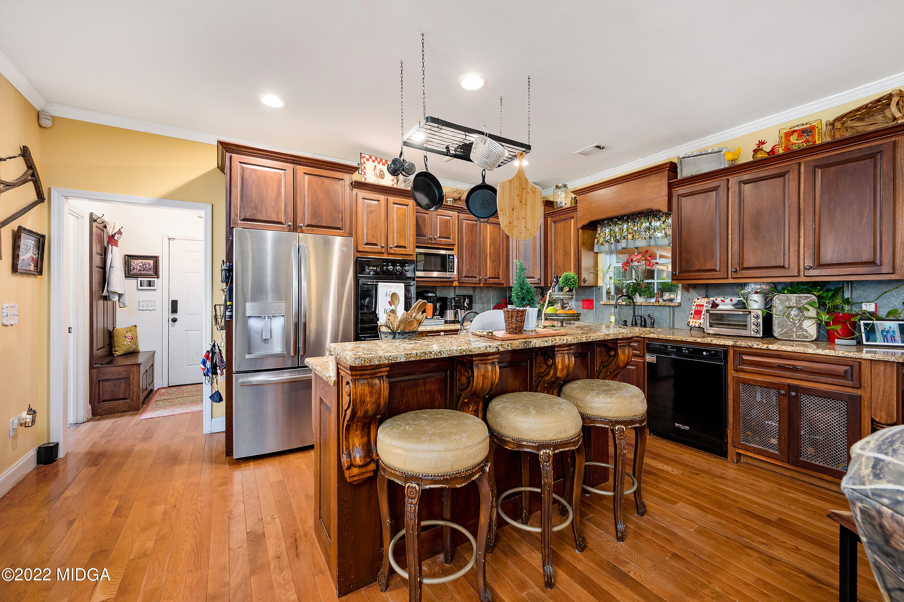 500 Gregory Road Forsyth, GA 31029 - Photo 15 of 47 a kitchen with stainless steel appliances granite countertop a table chairs and a refrigerator