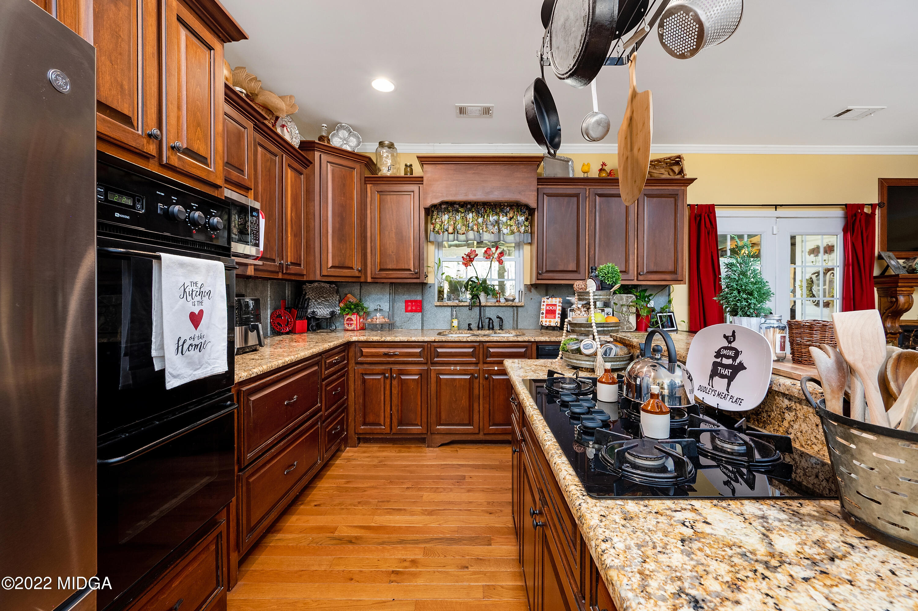 500 Gregory Road Forsyth, GA 31029 - Photo 16 of 47 a kitchen with granite countertop a stove and a refrigerator