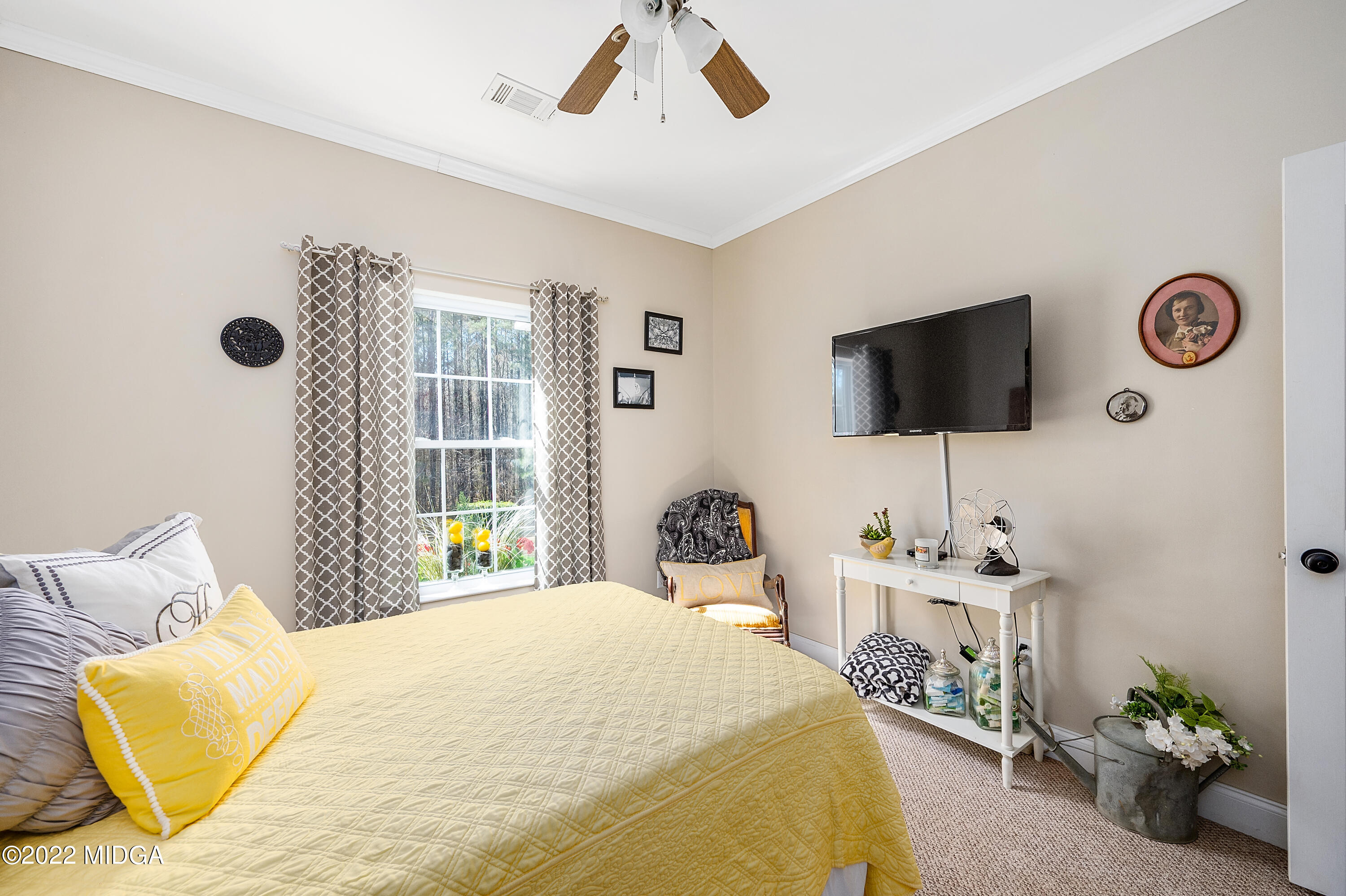 500 Gregory Road Forsyth, GA 31029 - Photo 26 of 47 a bedroom with a bed and a flat screen tv