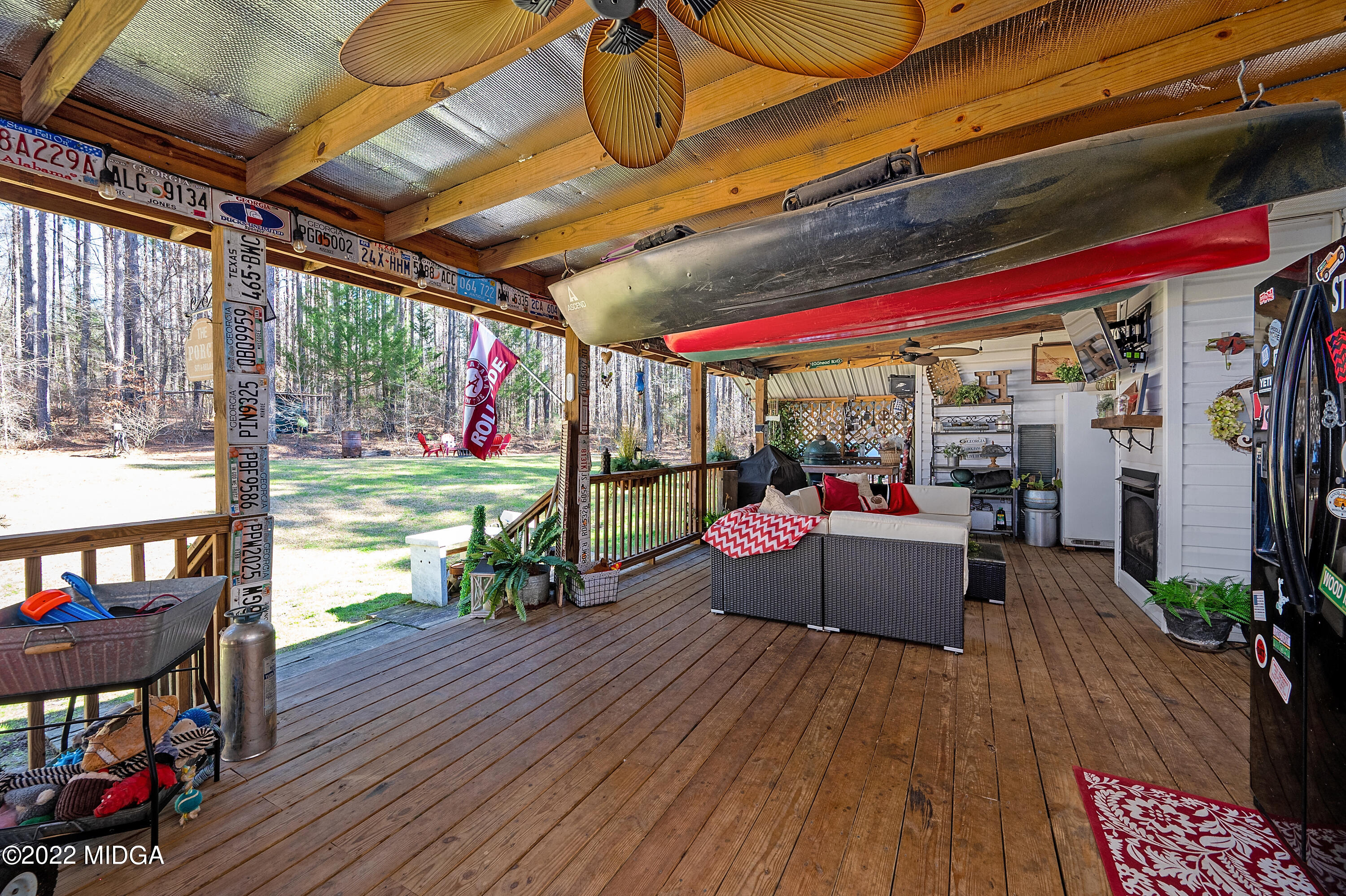 500 Gregory Road Forsyth, GA 31029 - Photo 31 of 47 a view of a patio with table and chairs potted plants with wooden floor