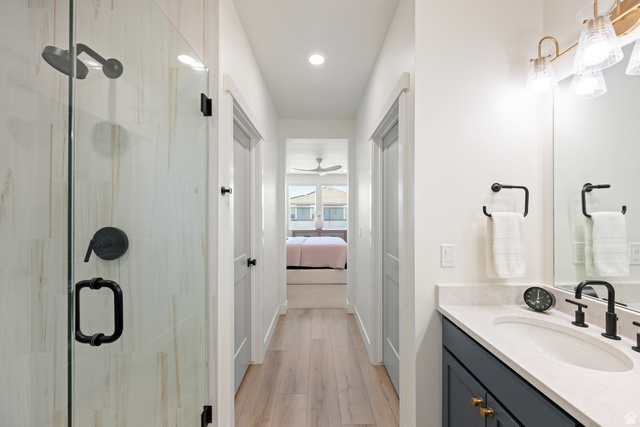 762 West Periwinkle Lane, Unit 102 St. George, UT 84790 - Photo 17 of 40 Ensuite bathroom featuring vanity, a stall shower, light wood finished floors, and recessed lighting