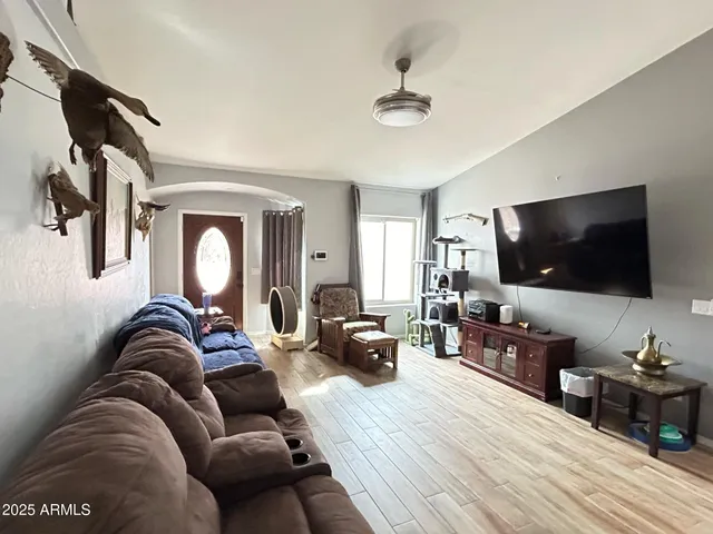 a living room with furniture and a flat screen tv