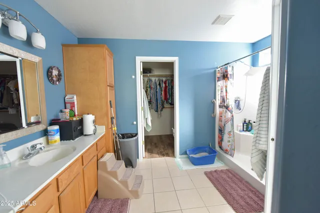 a bathroom with a double vanity sink and a large mirror