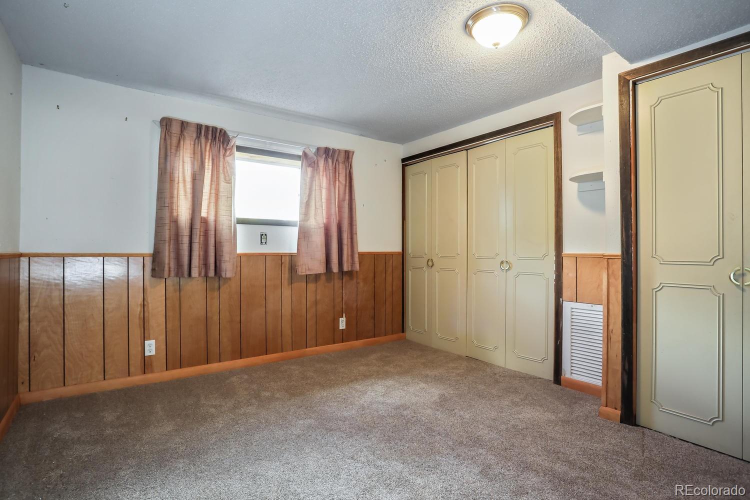 32038 Sylvan Road Golden, CO 80403 - Photo 24 of 28 an empty room with windows and closet