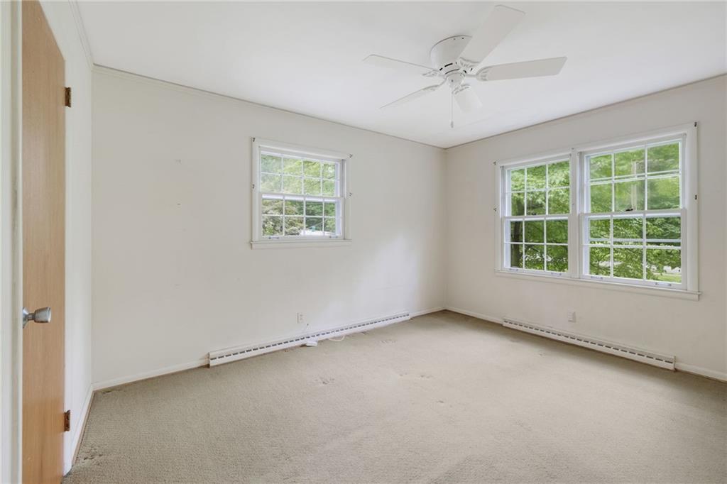 1911 Alderbrook Road Northeast Atlanta, GA 30345 - Photo 25 of 33 an empty room with a window and a ceiling fan