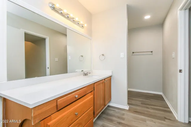 a room with a sink vanity and a mirror