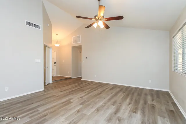 wooden floor in an empty room with a window