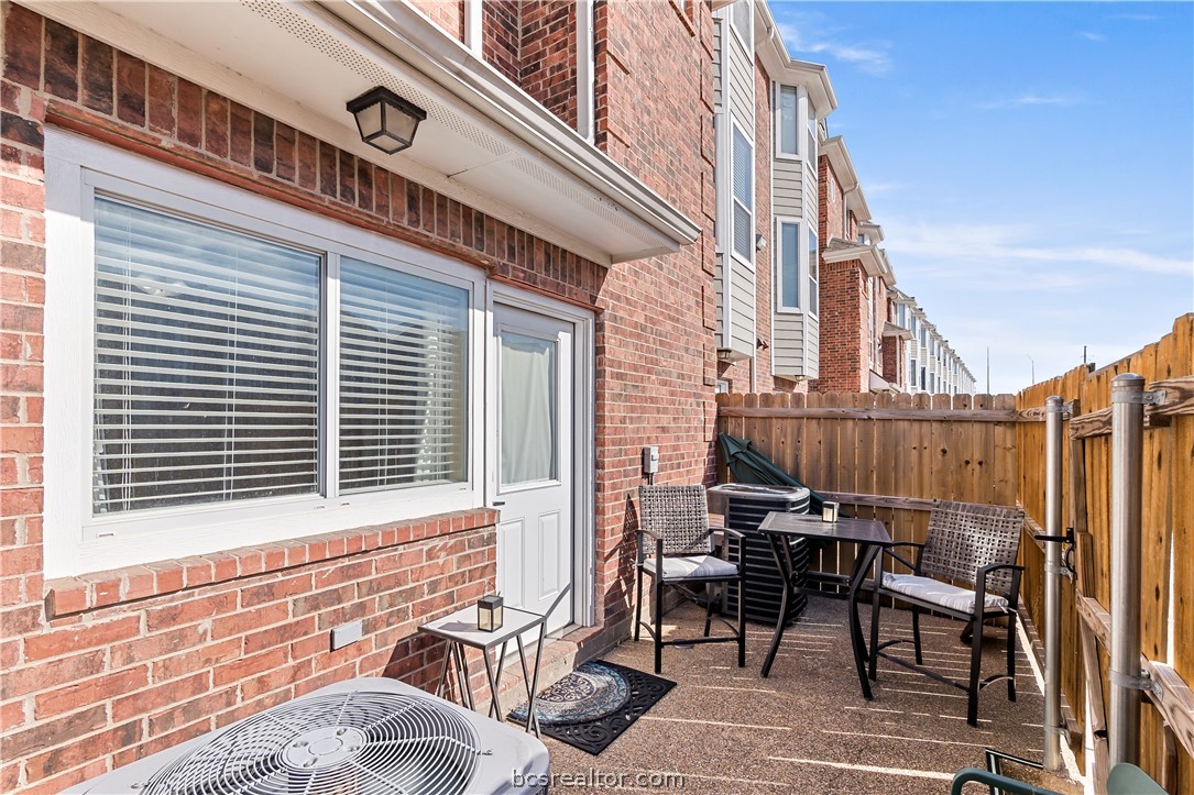 1198 Jones-Butler Road, Unit 1508 College Station, TX 77840 - Photo 15 of 18 a view of a patio with table and chairs and wooden floor