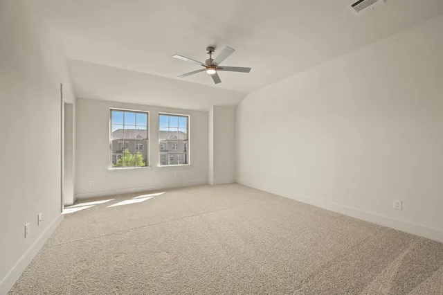 a kitchen with white cabinets and black appliances