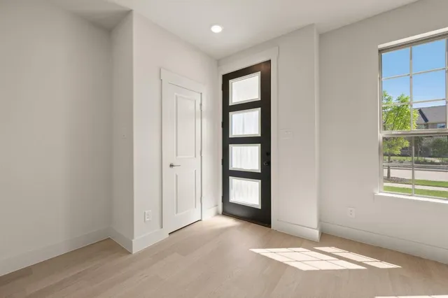 an aerial view of residential houses with outdoor space and ocean