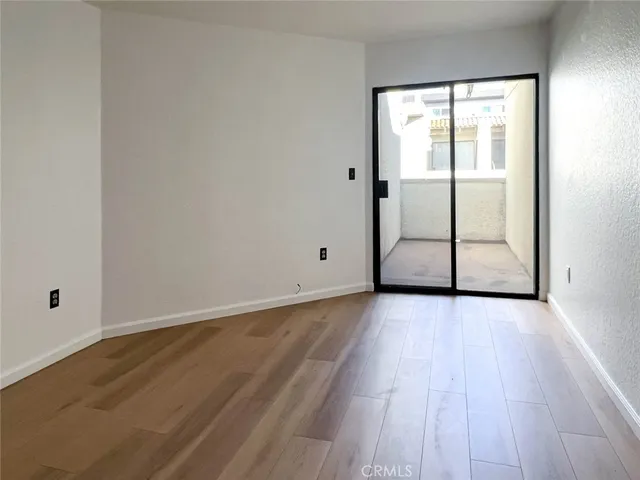 a view of a room with wooden floor and white walls