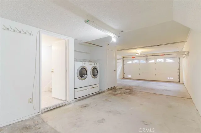 a view of a storage & utility room with a washer dryer