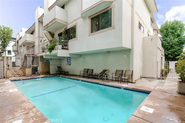 a view of a balcony with wooden floor and fence