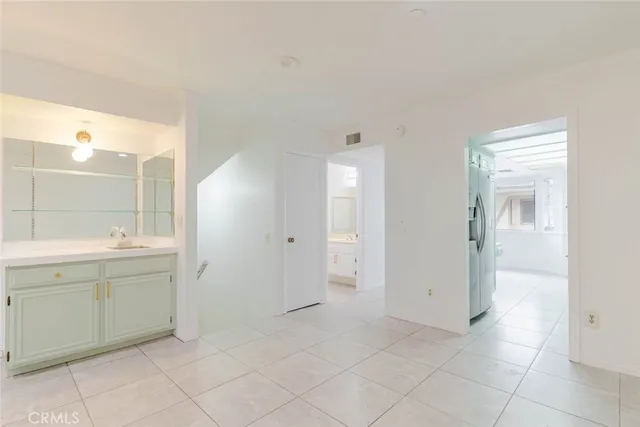 a spacious bathroom with a mirror sink and toilet