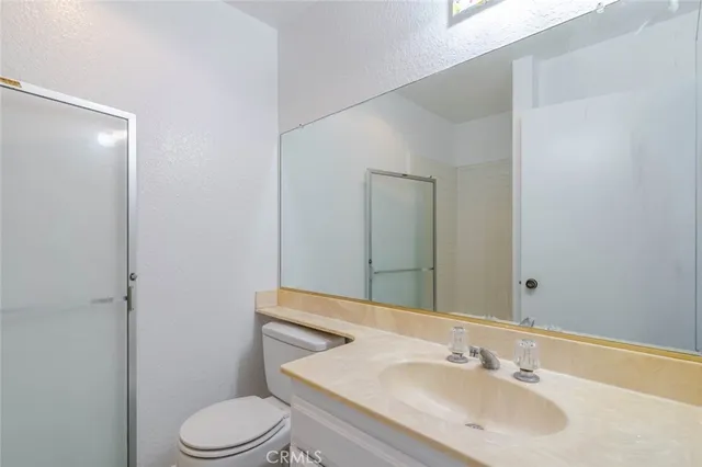 a bathroom with a sink toilet and mirror