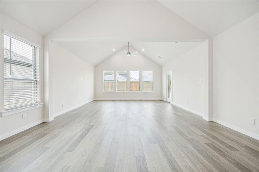 689 Moonlight Place Lavon, TX 75166 - Photo 12 of 29 an empty room with wooden floor and windows