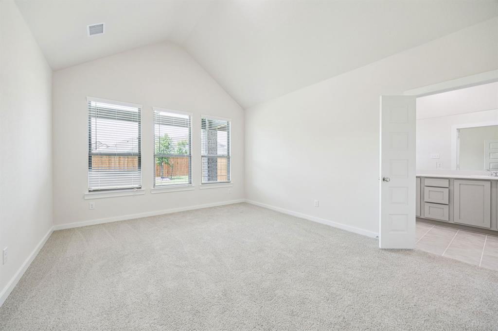 689 Moonlight Place Lavon, TX 75166 - Photo 15 of 29 an empty room with windows and refrigerator