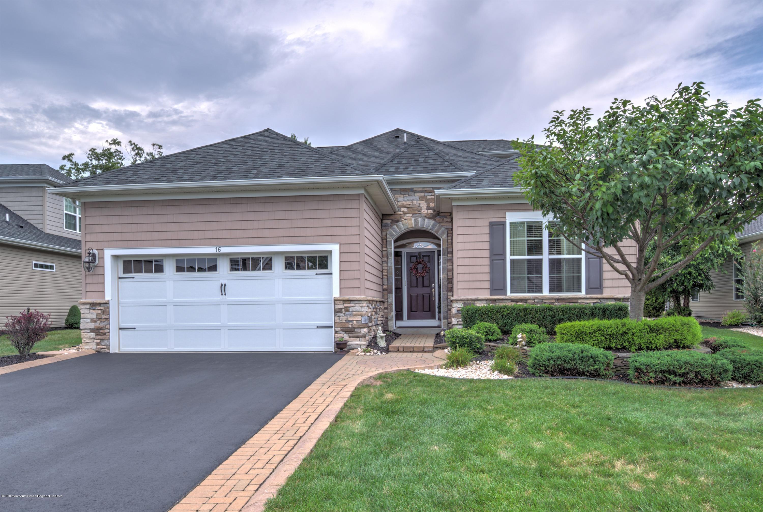 16 East Raphael Lane Farmingdale, NJ 07727 - Photo 1 of 50 a front view of a house with a yard and garage