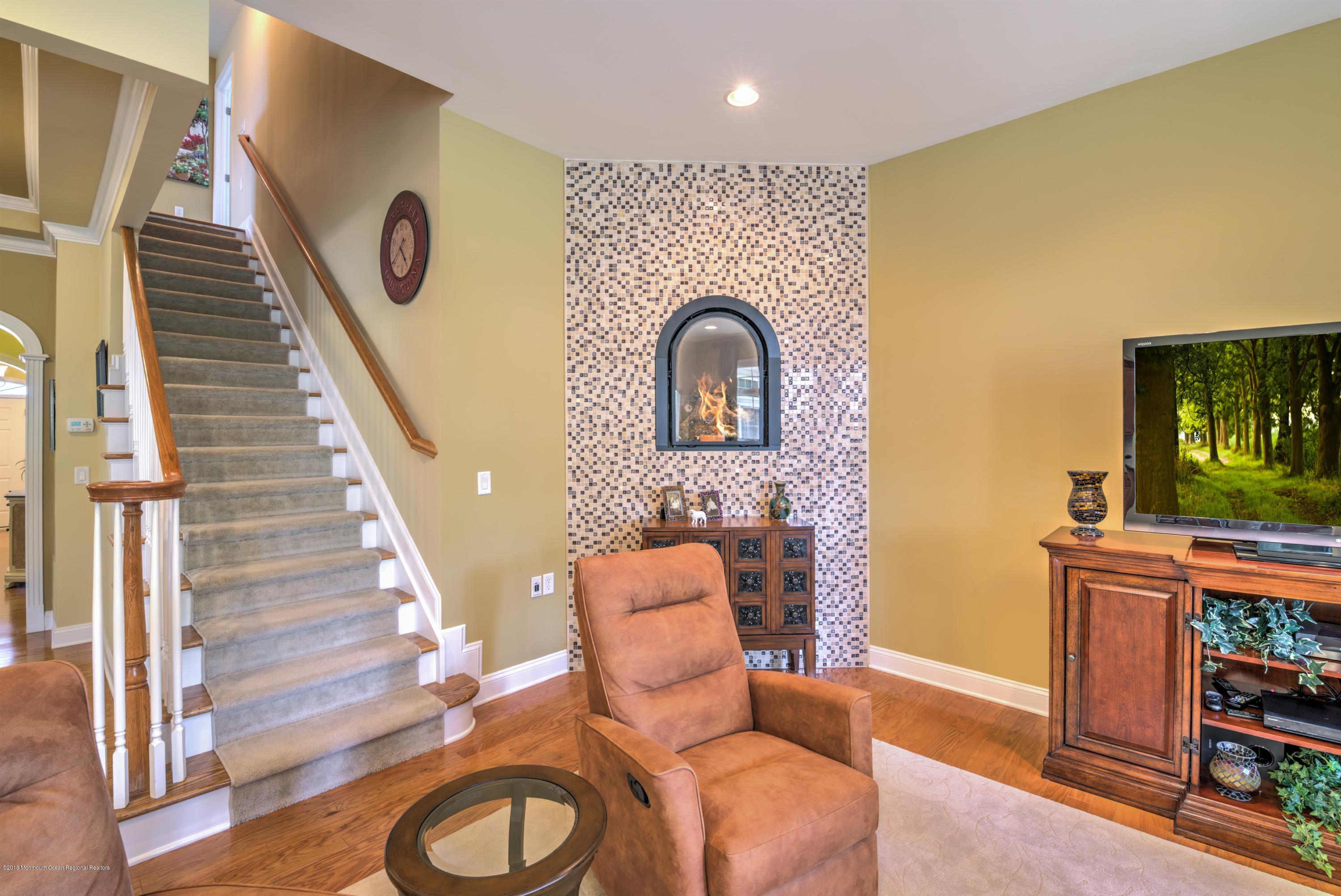 16 East Raphael Lane Farmingdale, NJ 07727 - Photo 12 of 50 a living room with furniture and a flat screen tv