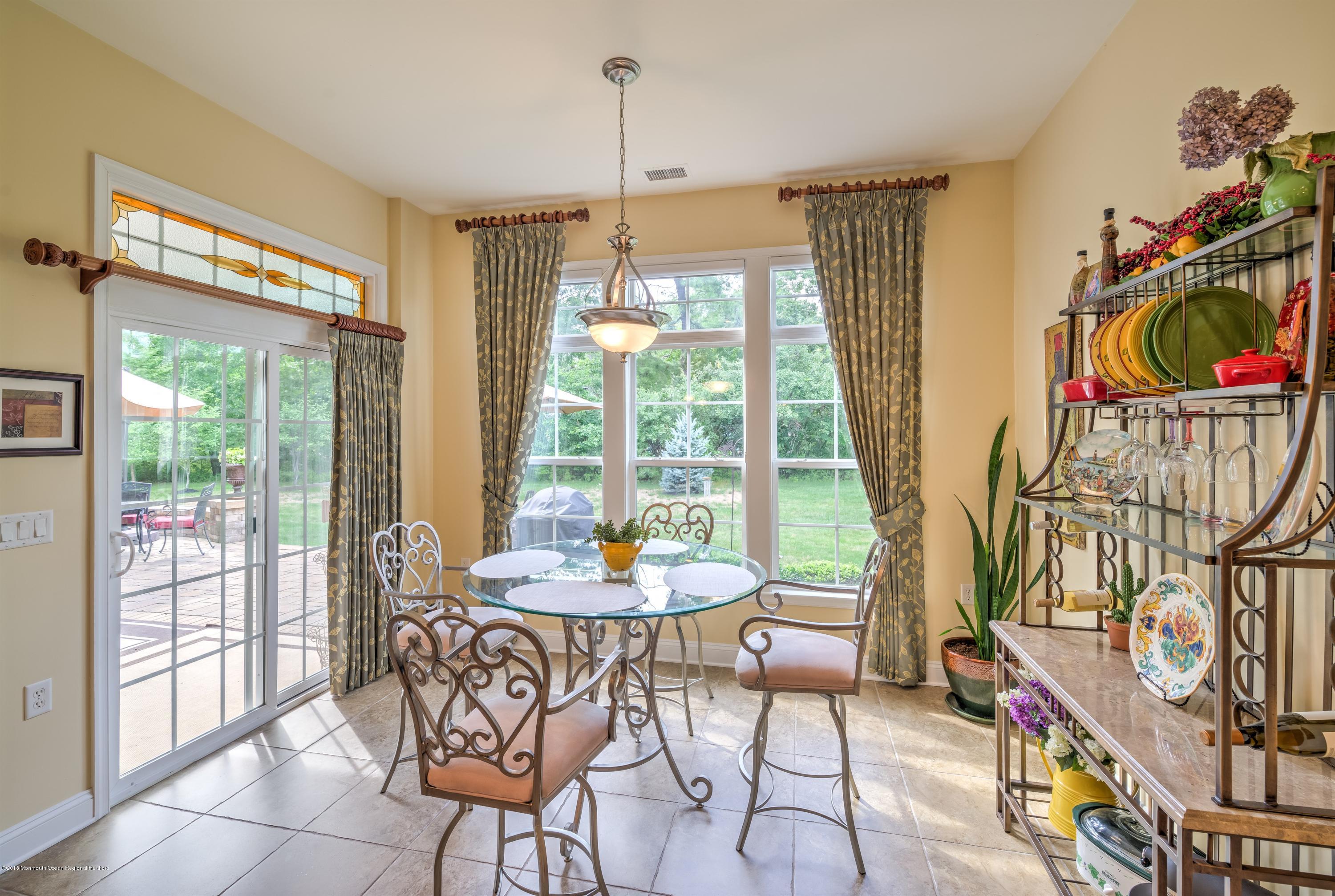 16 East Raphael Lane Farmingdale, NJ 07727 - Photo 15 of 50 a dining room with furniture water view and a chandelier