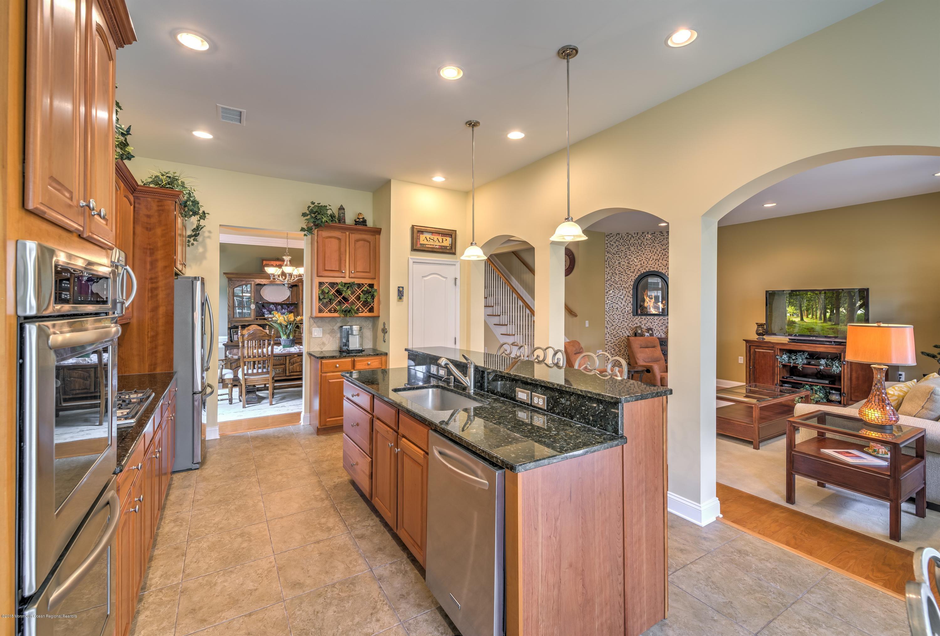 16 East Raphael Lane Farmingdale, NJ 07727 - Photo 16 of 50 a kitchen with stainless steel appliances granite countertop a stove and a refrigerator