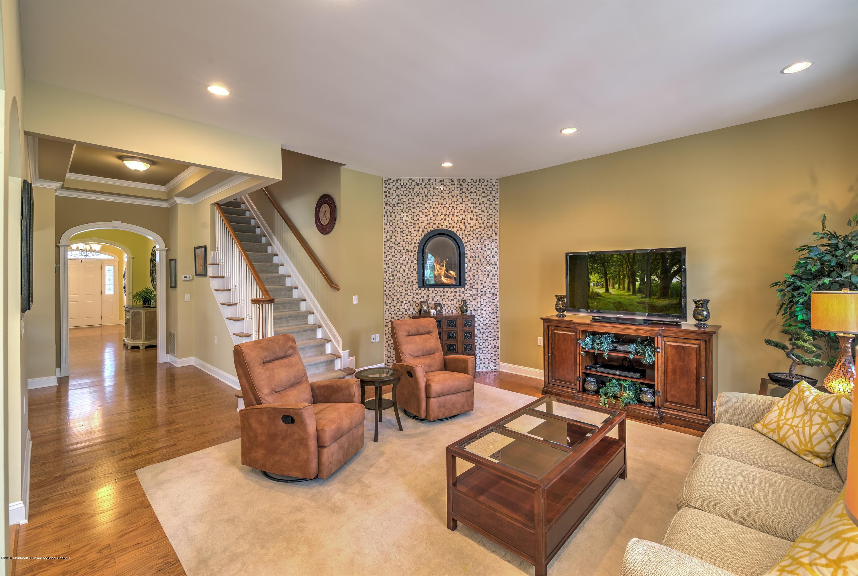 16 East Raphael Lane Farmingdale, NJ 07727 - Photo 2 of 50 a living room with furniture and a flat screen tv
