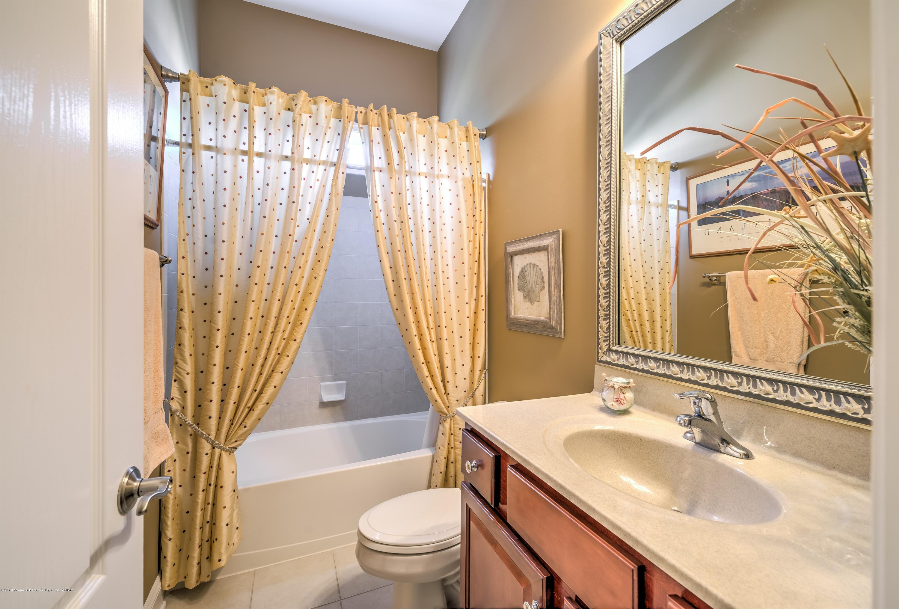 16 East Raphael Lane Farmingdale, NJ 07727 - Photo 23 of 50 a bathroom with a granite countertop sink toilet and shower
