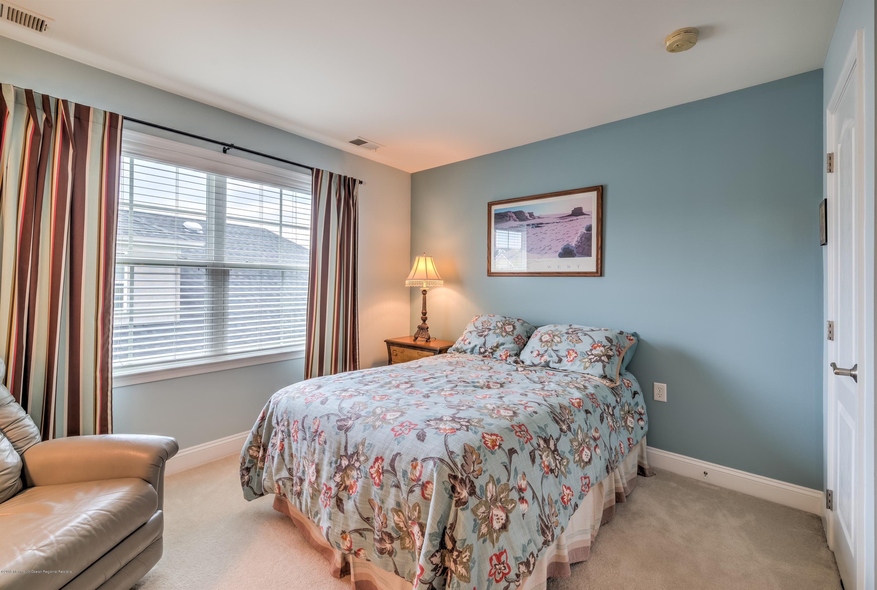 16 East Raphael Lane Farmingdale, NJ 07727 - Photo 24 of 50 a bedroom with a bed and a painting on the wall