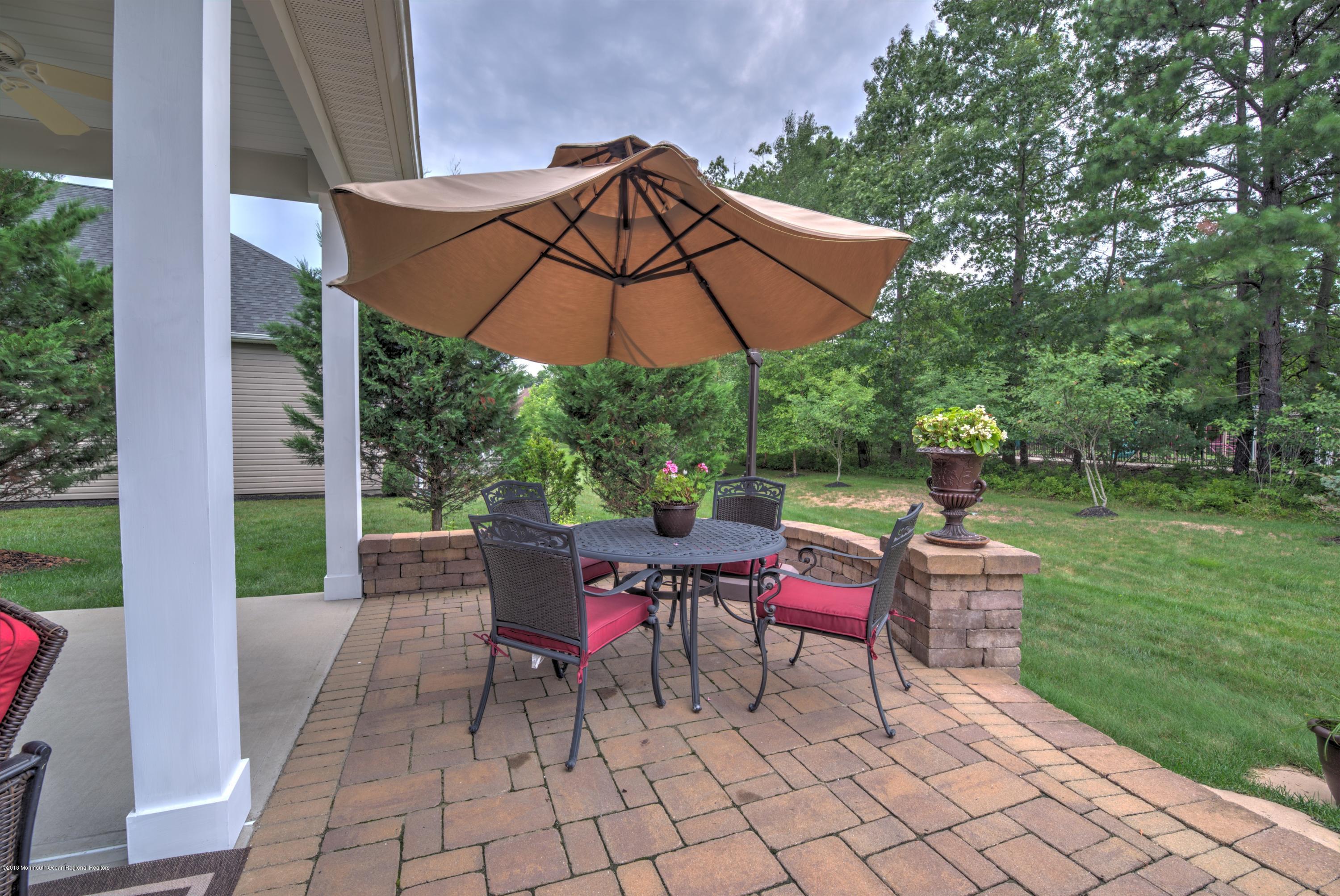 16 East Raphael Lane Farmingdale, NJ 07727 - Photo 29 of 50 a patio with a patio table and chairs