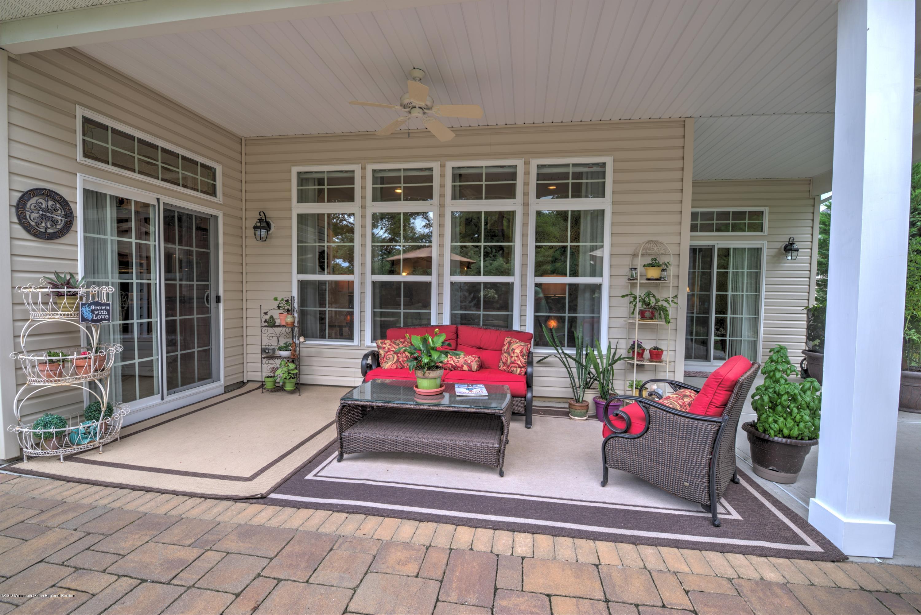 16 East Raphael Lane Farmingdale, NJ 07727 - Photo 30 of 50 a view of a two chairs in the patio and a potted plant