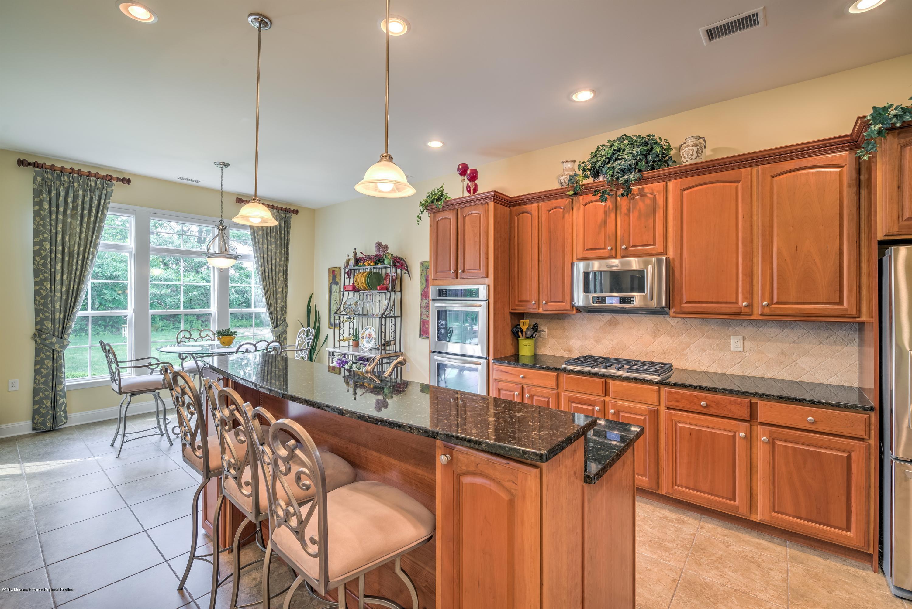 16 East Raphael Lane Farmingdale, NJ 07727 - Photo 3 of 50 a kitchen with stainless steel appliances granite countertop a stove a sink and a refrigerator