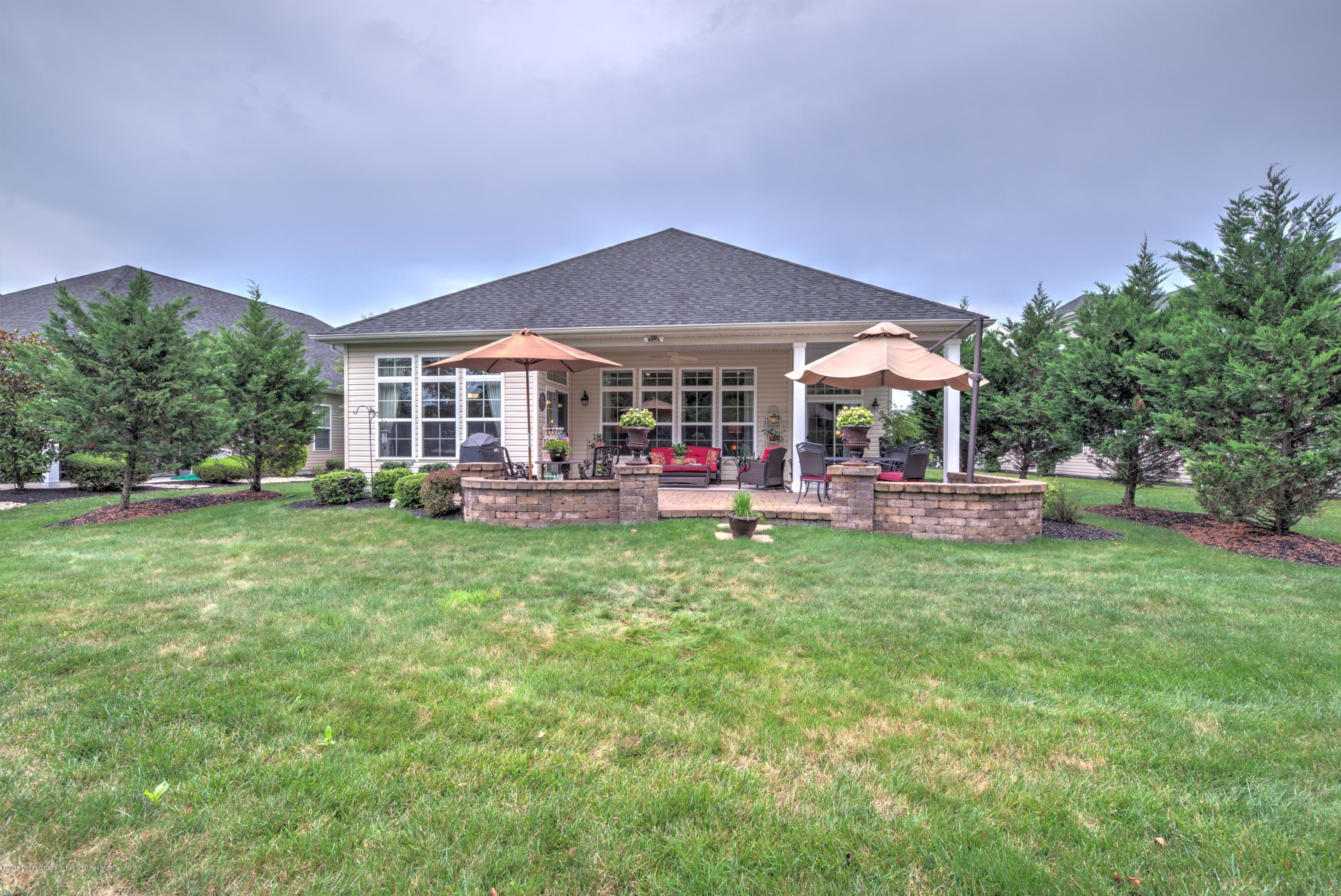 16 East Raphael Lane Farmingdale, NJ 07727 - Photo 32 of 50 a view of a house with a backyard and a patio
