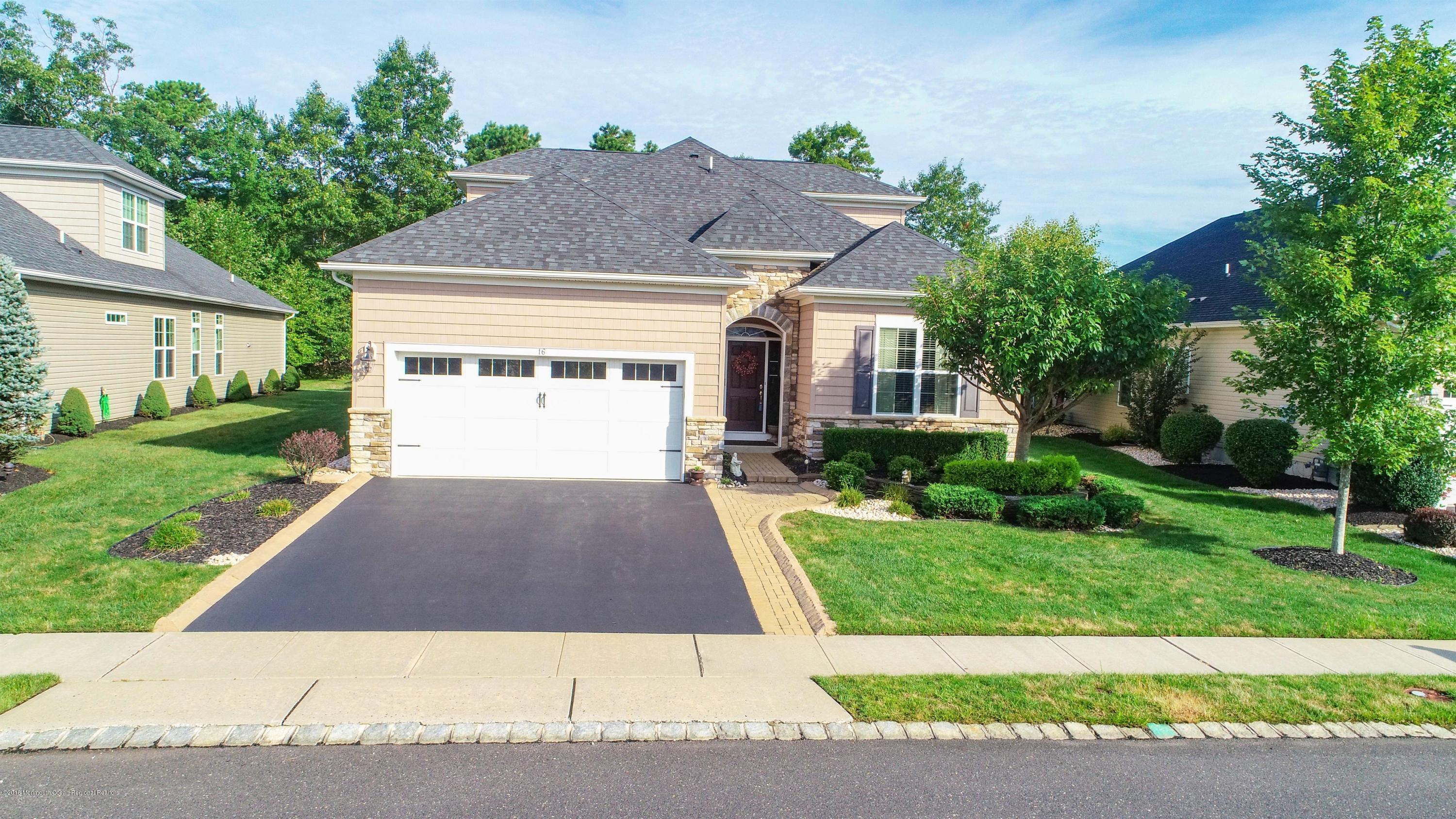 16 East Raphael Lane Farmingdale, NJ 07727 - Photo 34 of 50 a front view of a house with a yard and a garage