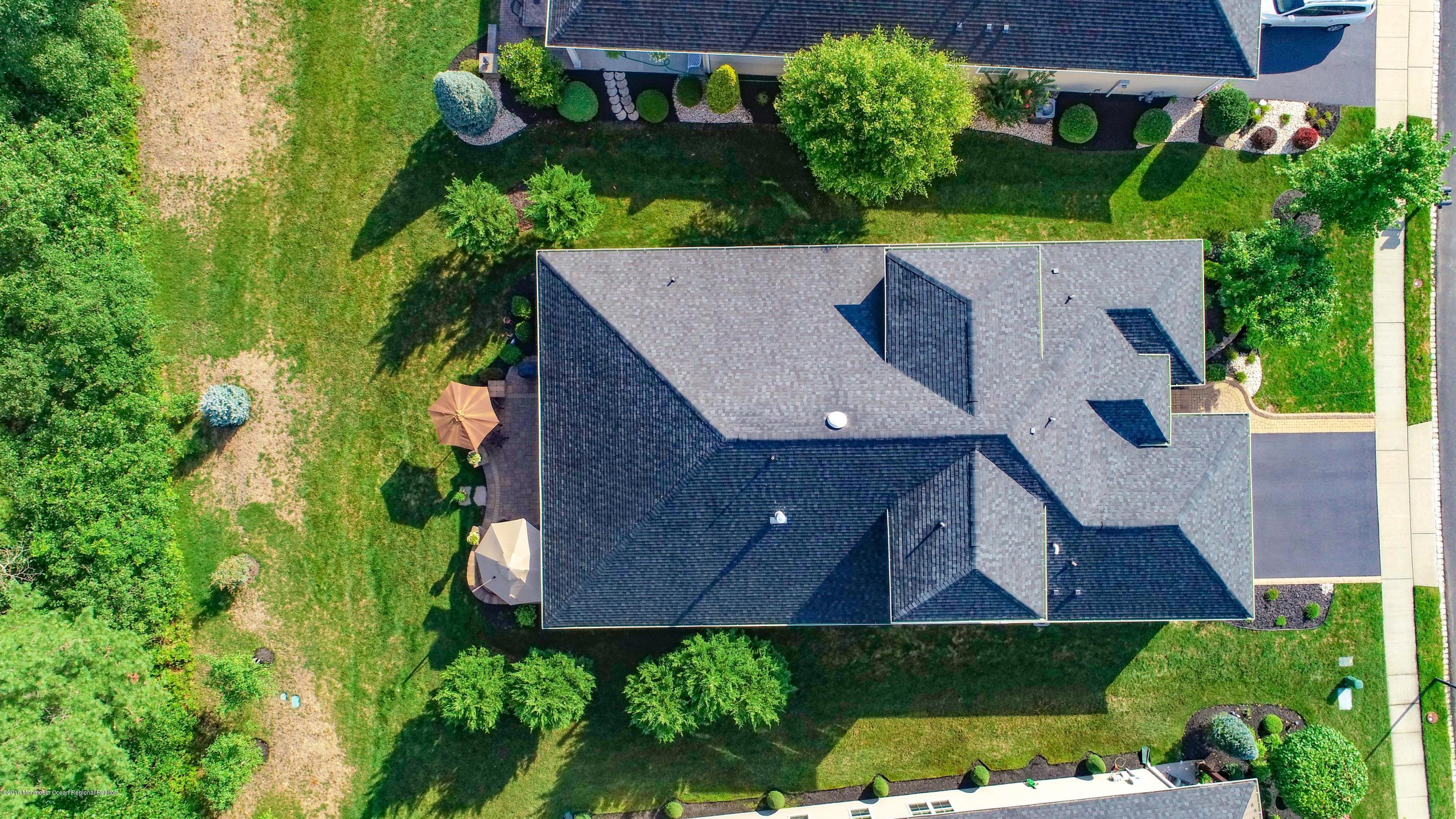 16 East Raphael Lane Farmingdale, NJ 07727 - Photo 37 of 50 an aerial view of a house with a yard and garden