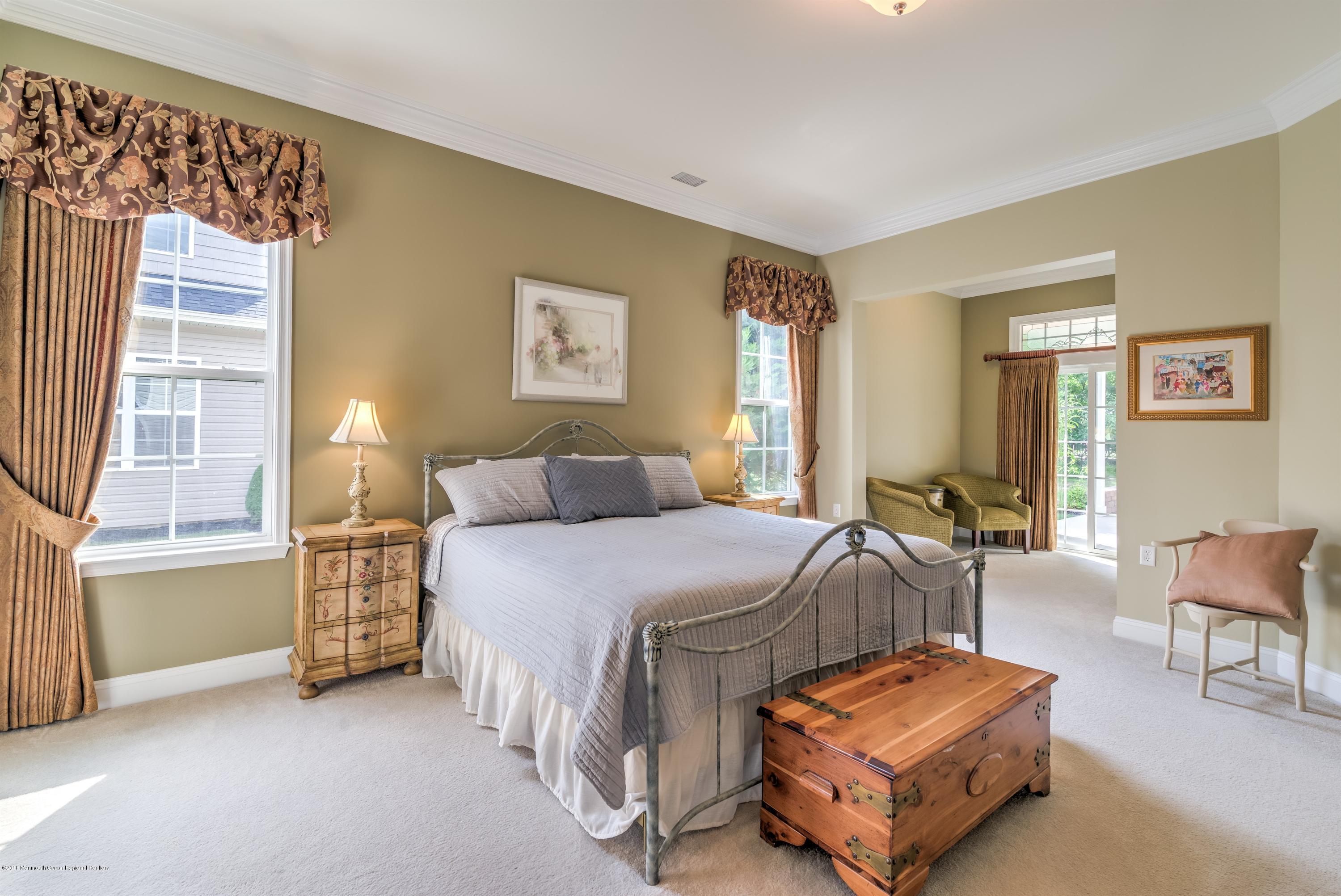 16 East Raphael Lane Farmingdale, NJ 07727 - Photo 4 of 50 a bed room with a bed and a chair