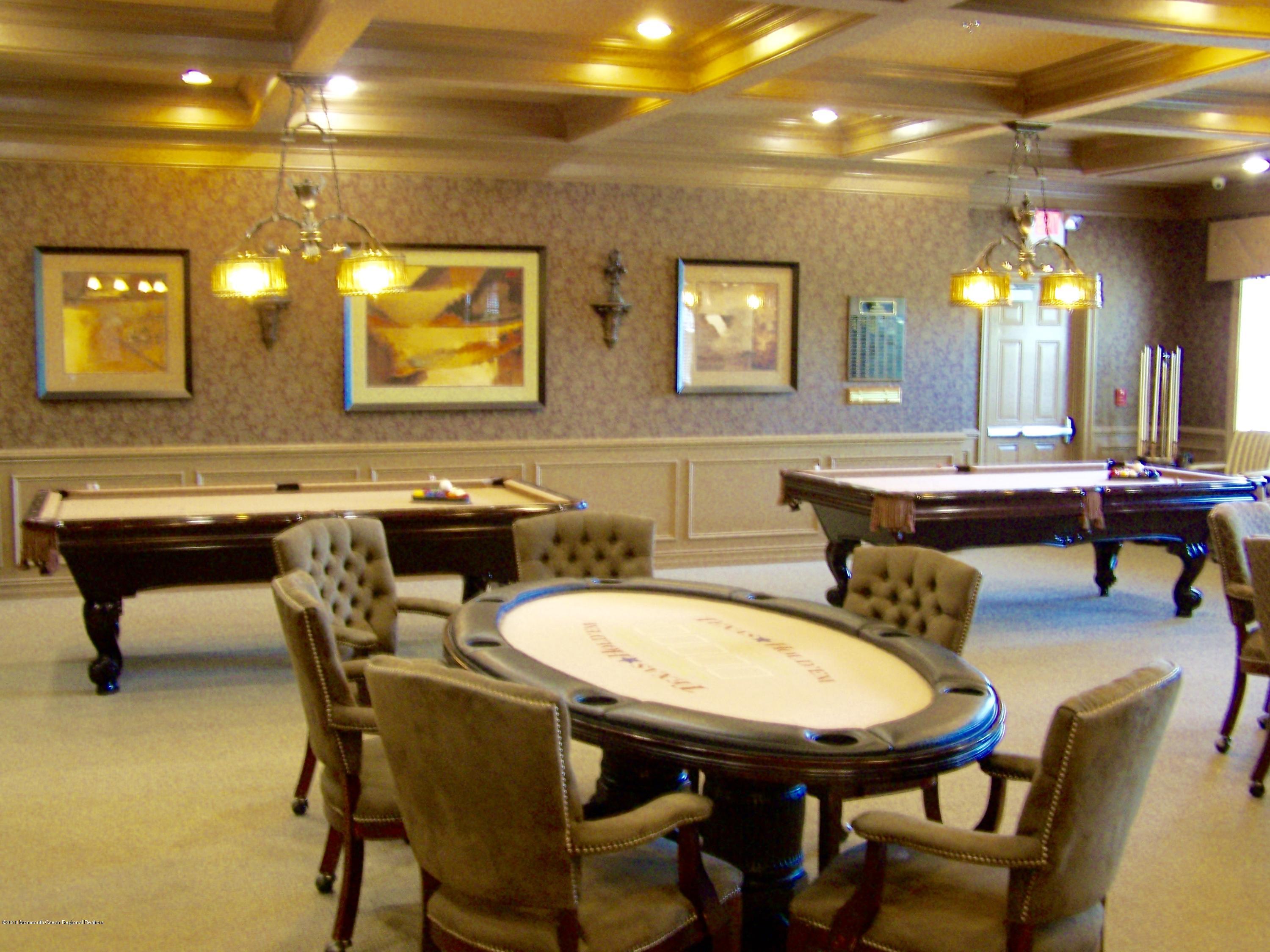 16 East Raphael Lane Farmingdale, NJ 07727 - Photo 49 of 50 a dining room with furniture and a chandelier