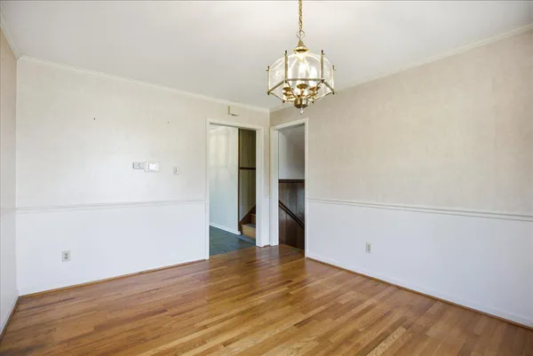 a kitchen with windows and white refrigerator