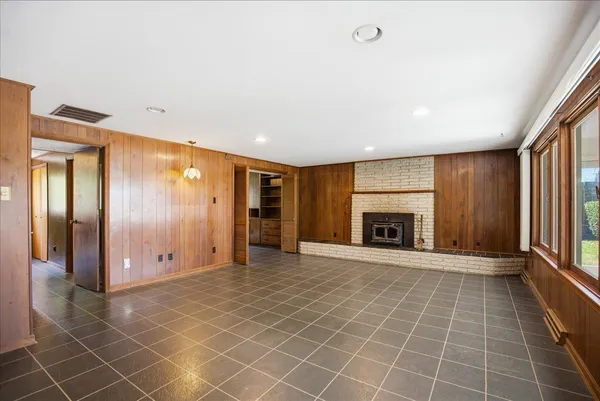 a view of a flesh screen tv and windows in an empty room