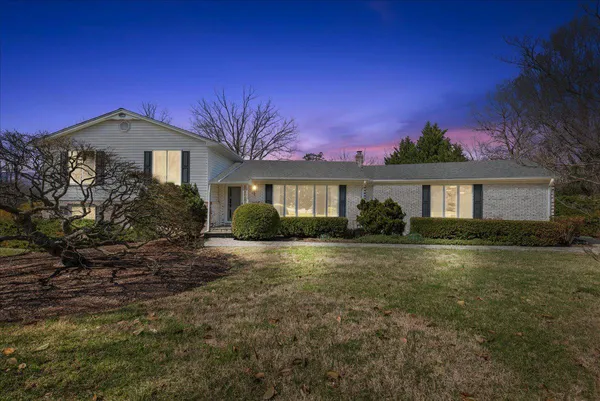 an aerial view of a house with a yard swimming pool and mountain view
