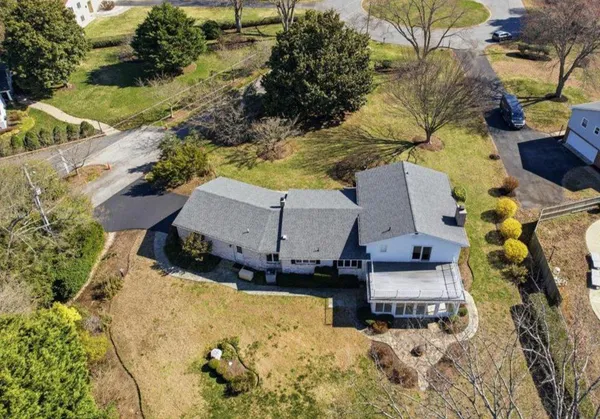 a view of staircase with railing and a chandelier